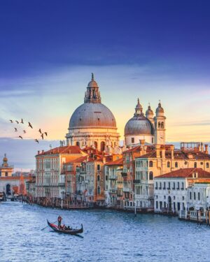 A Gondola Riding Through the Canals in Venice at Sunset | Luxury Italy Holidays | The Ultimate Travel Company
