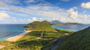 Nevis | Coastal landscape with hills, beach, and blue sea | The Ultimate Travel Company
