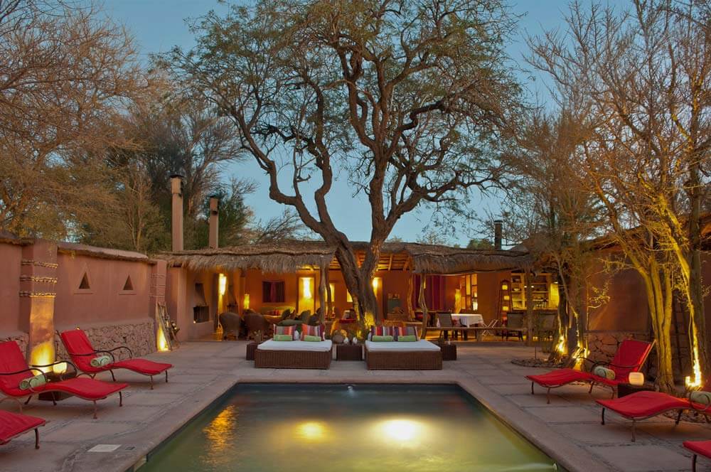 Awasi Atacama | Atacama Desert | Chile | An evening view of a tranquil pool area with loungers | The Ultimate Travel Company