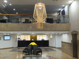 The Sebel Quay West Suites, Sydney | Hotel lobby with reception desk and modern chandelier | The Ultimate Travel Company