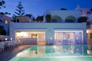Grace, Mykonos | Greece | Poolside restaurant at twilight | The Ultimate Travel Company