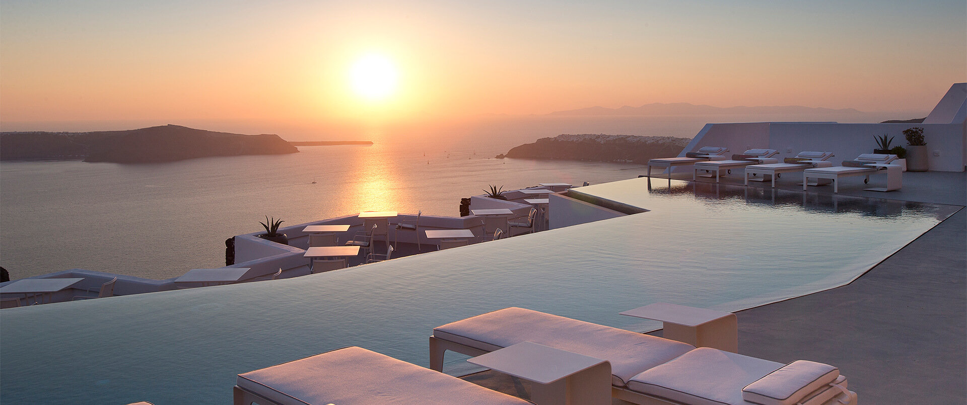 Grace, Mykonos | Greece | Sunset by an infinity pool in Santorini | The Ultimate Travel Company