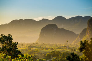 Vinales And Cayo Levisa | Lush Valley with towering limestone cliffs at sunset | The Ultimate Travel Company