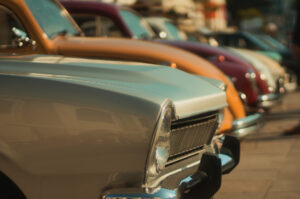 Havana | Row of classic cars in various colors parked on a street | The Ultimate Travel Company