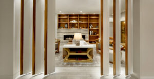 The James Hotel, Saskatoon | Canada | Elegant hotel suite entryway with a view into a cozy seating area and bookshelf | The Ultimate Travel Company