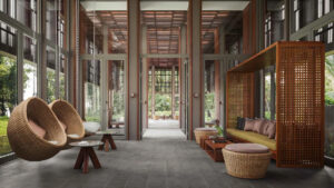 Koh Russey Villas & Resort | Cambodia | Lobby with hanging chairs and wooden decor | The Ultimate Travel Company