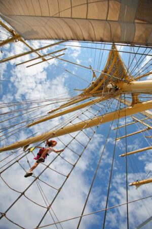 Star Clipper, Italy | Person climbing the rigging of a tall ship | The Ultimate Travel Company