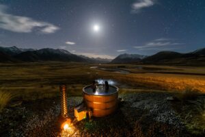 The Lindis, Ahuriri Valley | Night sky with stars over an outdoor hot tub | New Zealand | The Ultimate Travel Company