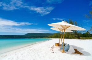 Song Saa Private Island Resort | Cambodia | White sand beach with beach umbrella | The Ultimate Travel Company