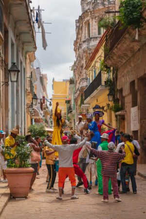 Havana | Street performers in colorful costumes dancing in a traditional festival | The Ultimate Travel Company