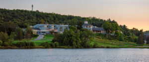 Deerhurst Resort, Huntsville | Canada | Lakeside resort with surrounding greenery during sunset | The Ultimate Travel Company