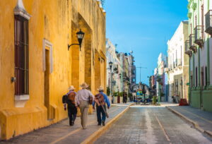 Musicians Walking Down a Colourful Street in Mexico City | Mexico Holidays | The Ultimate Travel Company