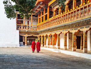 Two Monks Walking in a Temple | Bhutan Holidays | The Ultimate Travel Company