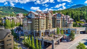 The Westin Resort & Spa, Whistler | Canada | Exterior view of The Westin Resort & Spa, Whistler, with a backdrop of lush green mountains | The Ultimate Travel Company