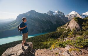 Stoneridge Mountain Resort, Canmore | Canada | man posing at the top of the mountain | The Ultimate Travel Company