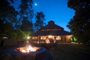 Tiger Tops Karnali Lodge, Bardia National Park | Nepal | Tiger Tops lodge exterior at night | The Ultimate Travel Company