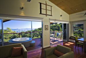 O’reilly’s Rainforest Retreat, Lamington National Park | Queensland | Interior of a room with a deck and mountain view | The Ultimate Travel Company