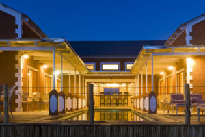 River Crossing Lodge, Windhoek | Namibia | The front view of River Crossing Lodge at night | The Ultimate Travel Company
