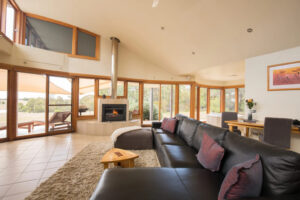 Boroka Downs, Grampians National Park | Australia | A bright living room with a sofa and fireplace | The Ultimate Travel Company