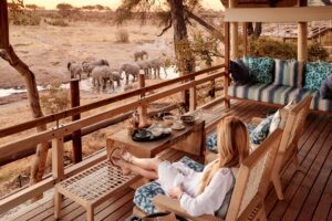 Woman Relaxing on the Terrace at Savute Elephant Lodge | Luxury Botswana Safaris | The Ultimate Travel Company