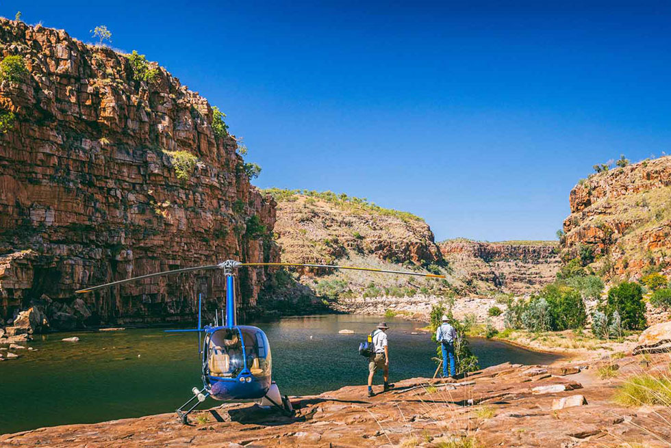 El Questro Homestead, Kununurra | Australia | Helicopter by a gorge with two people | The Ultimate Travel Company