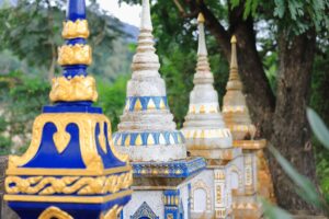 Small Stupas on the Outer Gate of Wat Pha Singkham in Muang La | Laos Holidays | The Ultimate Travel Company