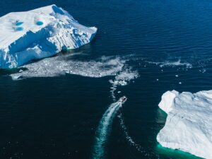 Boat,Navigating,Through,Icefield,Seen,From,The,Drone