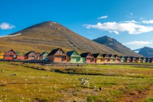 Colourful Old Coal Mining Houses on the Hills of Longyearbyen | Luxury Arctic Holidays | The Ultimate Travel Company