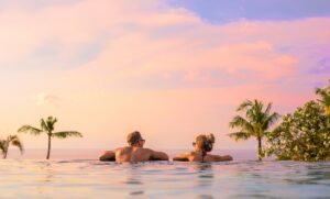 Romantic Couple Looking at Sunrise on Luxury Honeymoon | The Ultimate Travel Company