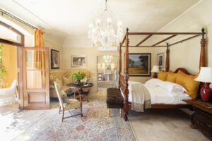 A Luxury Suite Bedroom with a Four Poster Bed at La Residence Franschhoek | South Africa | The Ultimate Travel Company