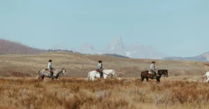 Three People Horse Riding Across the Wild West in Wyoming at the Goosewing Ranch | Ranch Holidays in the USA | The Ultimate Travel Company