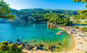 Beautiful Beach and Boats in Paleokastritsa in Corfu, the Greek Islands | Luxury Greece Holidays | The Ultimate Travel Company