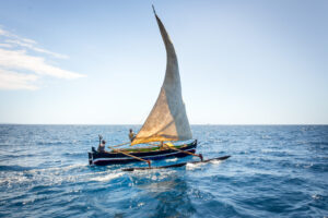View,Of,Nosy,Komba,Island,Coastline,With,A,Sail,Boat