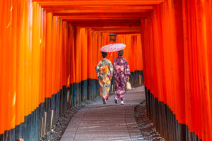 Women in traditional japanese kimonos walking at Fushimi Inari Shrine in Kyoto, Japan