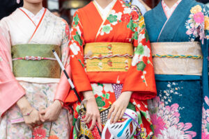 Young girl wearing Japanese kimono standing in front of Sensoji Temple in Tokyo, Japan. Kimono is a Japanese traditional garment. The word